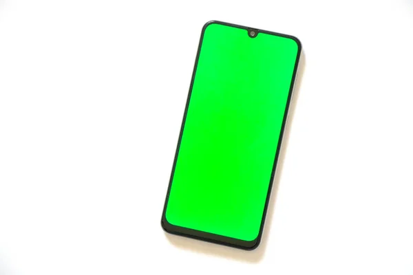浅色背景上带有绿色屏幕的触摸屏电话 — 图库照片
