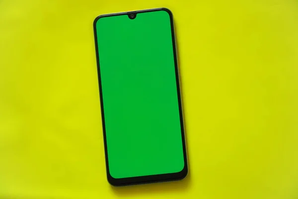 touchscreen phone with a green screen on a light background