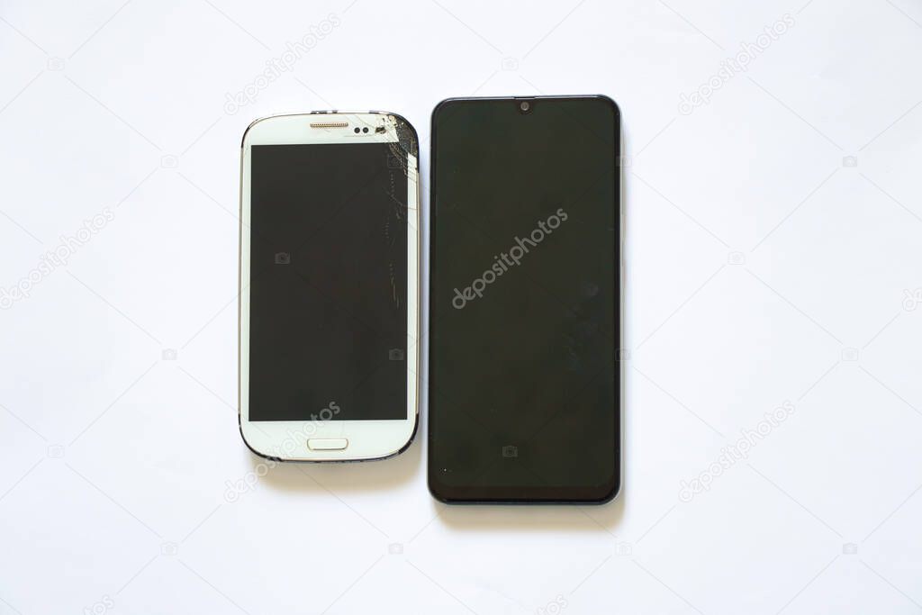 broken white phone after falling and near the whole phone on a white background