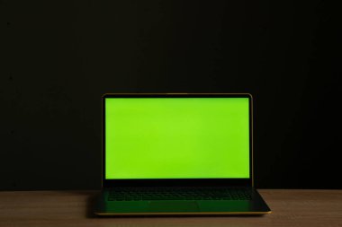 a laptop with a green screen stands clipart