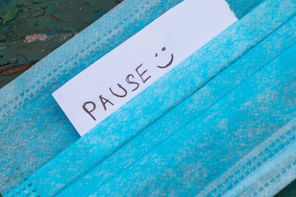 在检疫期间 床单上的英文 Pause 一词出现在医疗面罩上 — 图库照片