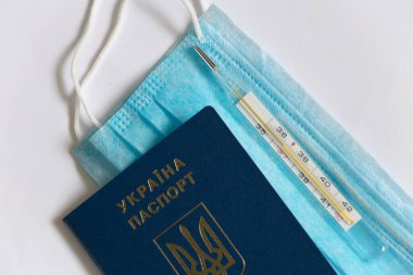 Tıbbi termometre yalan söylüyor ve Ukrayna pasaportunda tıbbi maske var.