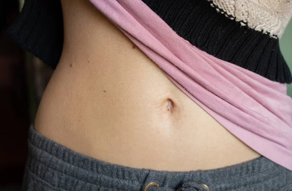 belly of a young girl with a belly button closeup