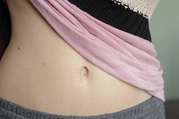 belly of a young girl with a belly button closeup