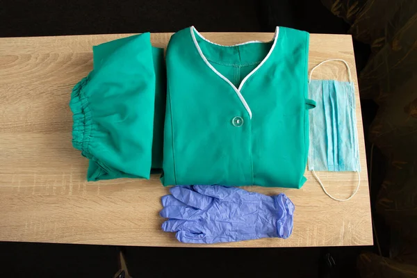 medical uniform set folded on isolated background nurse