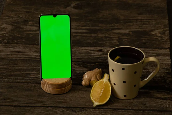 Mobiltelefon Mit Grünem Bildschirm Und Einer Tasse Tee Mit Zitrone — Stockfoto