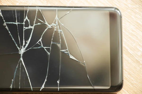 black phone with cracked screen on an isolated background