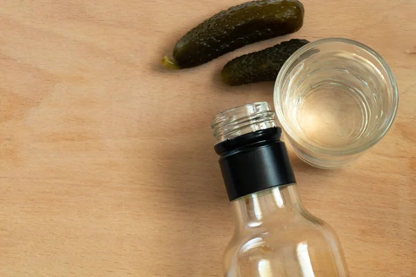 Bottle Vodka Glass Two Pickled Cucumbers Wooden Table Close — Stock Photo, Image