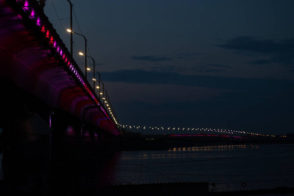 Old bridge in the evening with backlight in the city of Dnieper