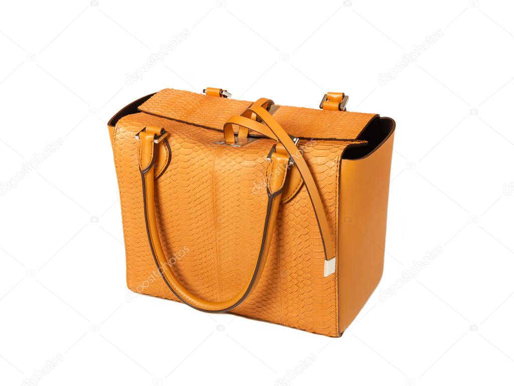 Yellow women bag made of python skin on a white background half side