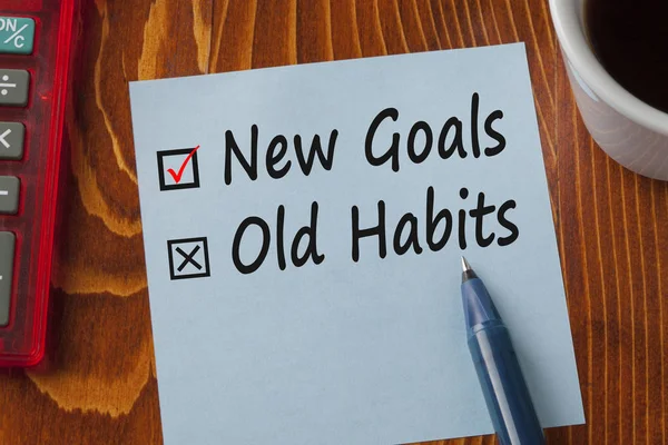 New Goals Old Habits written on note concept
