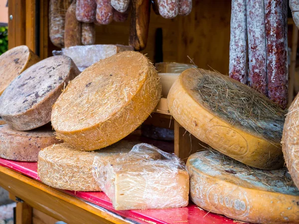 Cheese wheels on open air market stall — ストック写真