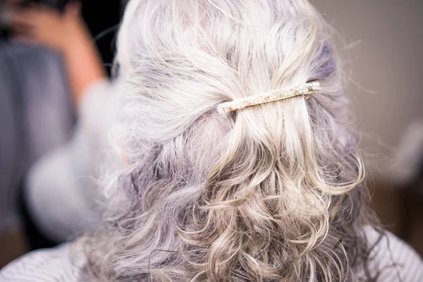 Brooch in mature womans hair — Stock Photo, Image