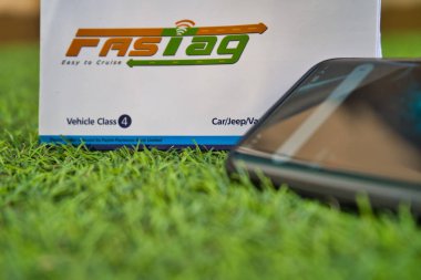 Cep telefonuyla yeşil çimlerde hızlı etiket.