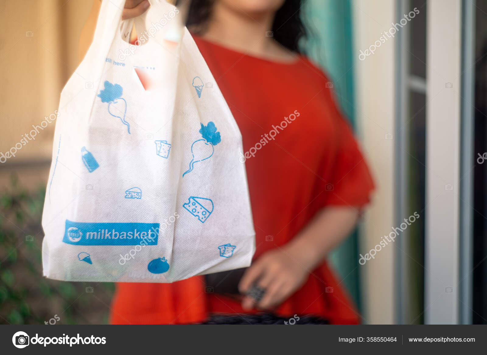 White milkbasket bag on grass outside a house showing daily subscription  deliveries from this e-com player Stock Photo - Alamy