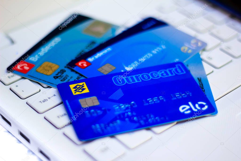 December 24, 2019, Brazil. In this photo illustration several credit cards of Banco Bradesco and Banco do Brasil on top of computer keyboard.