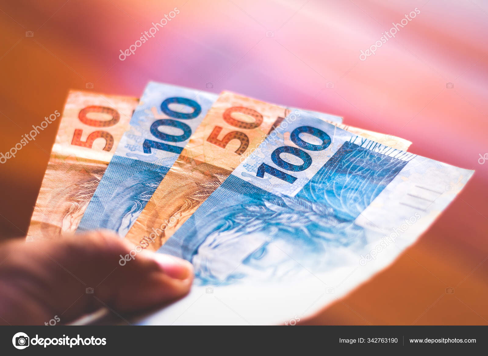 人手里拿着一百五十雷亚尔的钞票。巴西货币、经济和金融概念——图库图片© rafapress #342763190