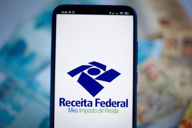 April 26, 2020, Brazil. In this photo illustration the app Receita Federal - Meu Imposto de Renda logo is displayed on a smartphone. clipart