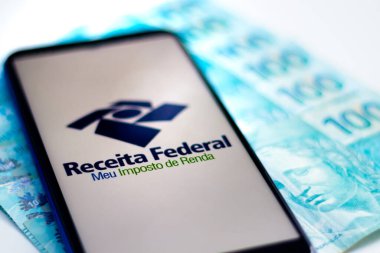 April 26, 2020, Brazil. In this photo illustration the app Receita Federal - Meu Imposto de Renda logo is displayed on a smartphone. clipart