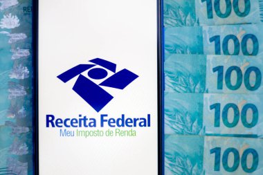 April 26, 2020, Brazil. In this photo illustration the app Receita Federal - Meu Imposto de Renda logo is displayed on a smartphone. clipart