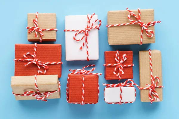 Collection of handcrafted gift boxes on light blue background.