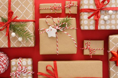 Various decorated gift boxes on red background.