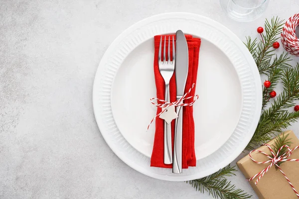 Christmas table setting with plates, red napkin, fork and knife. — Stock Photo, Image