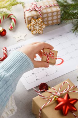 Çocuk eli, Noel hediyesi kutusunu planlama sayfasından alıyor.
