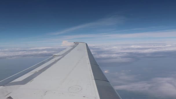 Wing of an airplane flying above the clouds. — Stock Video
