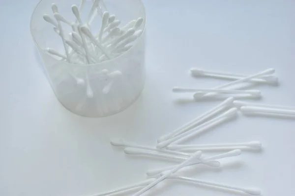 Ear cotton buds in a jar and scattered on white paper. Ear cotton buds in a jar and scattered on white paper. Earwax is obtained by using a small spatula at the end; at this time, you must beware of accidentally pushing the sulfur even further. If wa