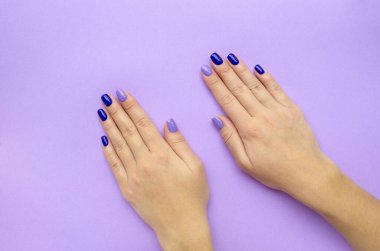 Stylish trendy women's manicure. Blue and lilac