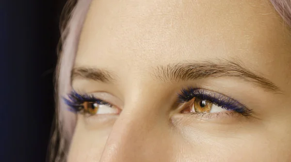 The lashes are black with splashes of blue.