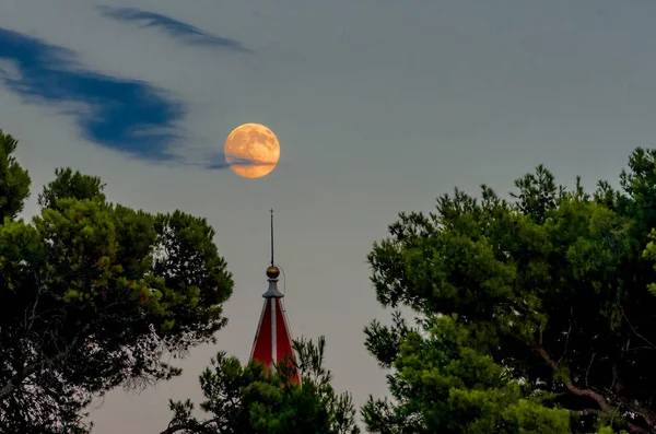 The magic moon in the evening over the resort town