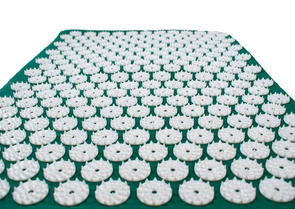 Acupressure mat for back and neck pain relief and muscle relaxation isolated on a white background. Relieves stress, pain.