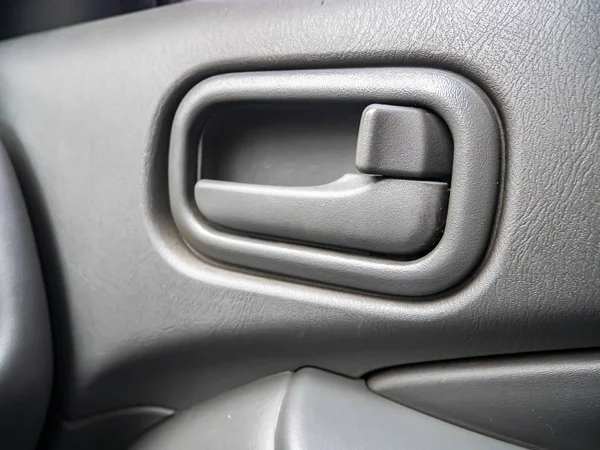 The handle to open the door of the car from the inside.