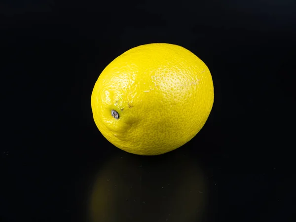 Yellow lemon fruit on a black background with place for text. — Stock Photo, Image