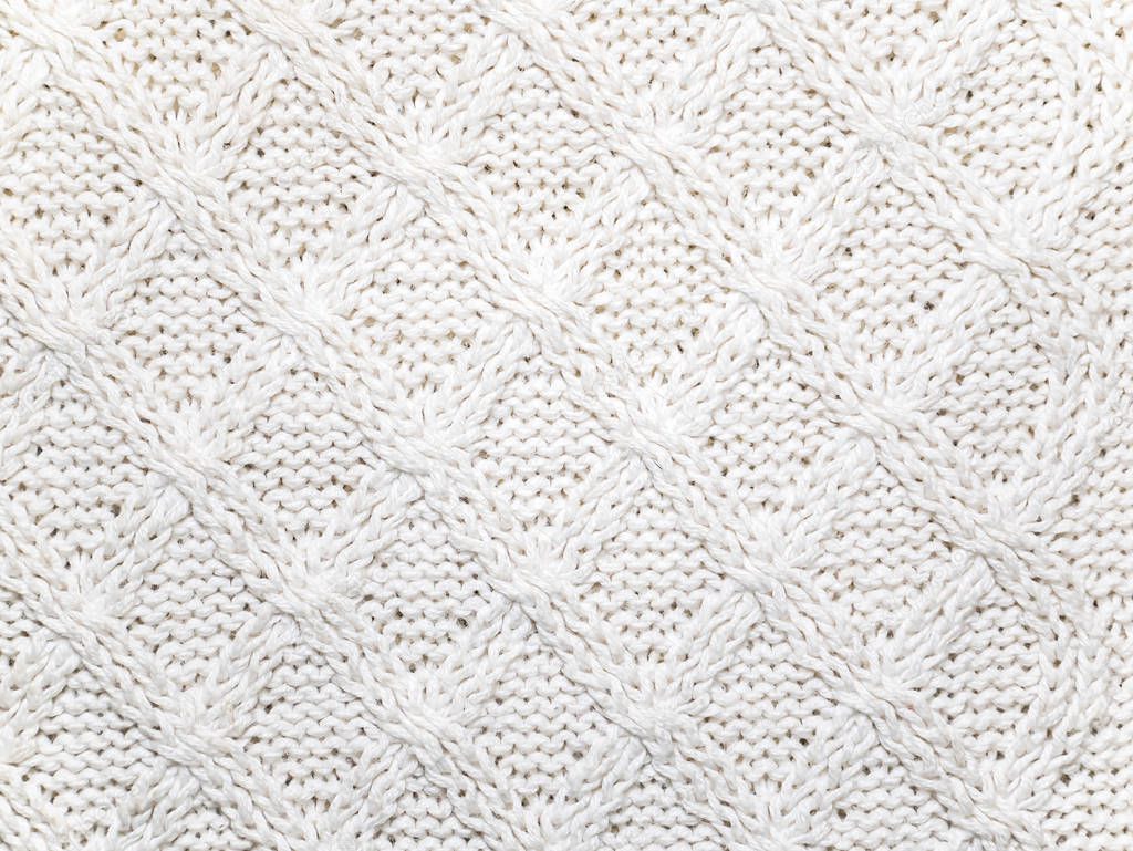 Texture of white woolen knitted fabric.