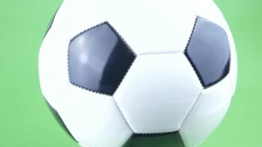 Yeşil arka planda dönen futbol topu. Futbol mu? Şampiyonluk. Avrupa. Dünya. Olimpiyatlar. Spor..