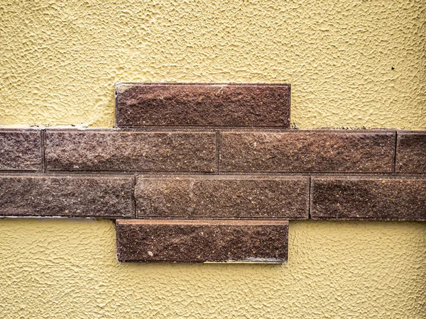 Wall with ceramic tiles in the form of stone bricks. Background image. Template for text. Background image. Place for text. The decor of the building. Building sector.