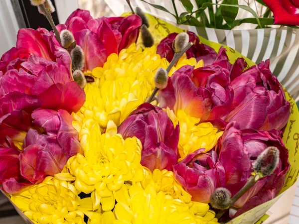 Festive bouquet of red and yellow flowers. Aster. Chamomile. Tulips Birthday. Bridal bouquet. Mothers Day. Valentine\'s Day. Place for text. Showcase flower shop.