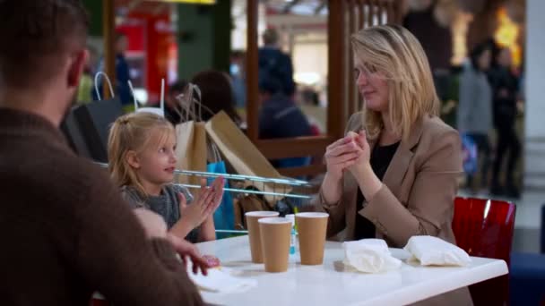 Family use a hand sanitizer to clear their hands — Stock Video