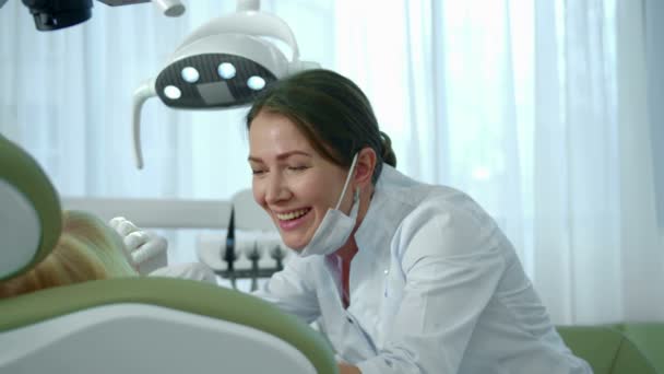 Доктор посмотрел на зубы девочек и продолжил говорить с ней. . — стоковое видео