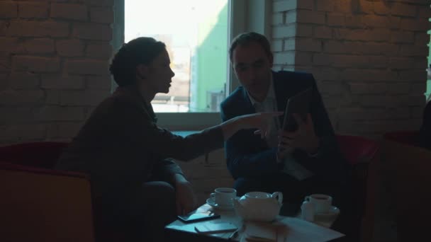 Business meeting, partners look on tablet and discuss — Stock Video