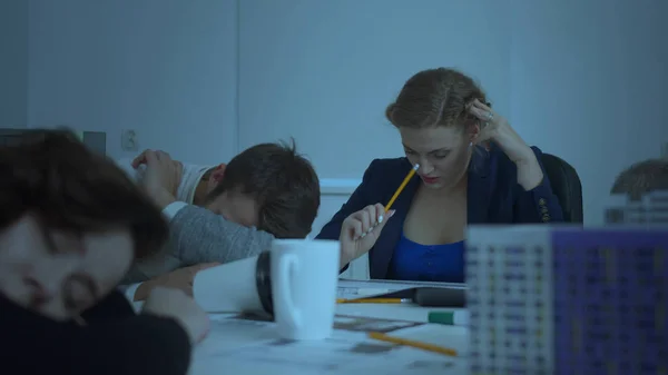 Office workers sit and sleep, woman drink coffee and try to work