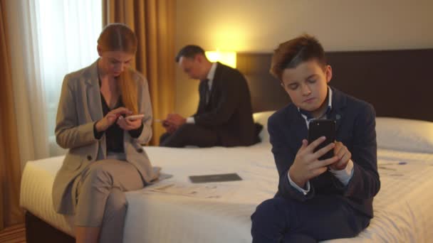 Family work on phones in hotel room — Stock Video