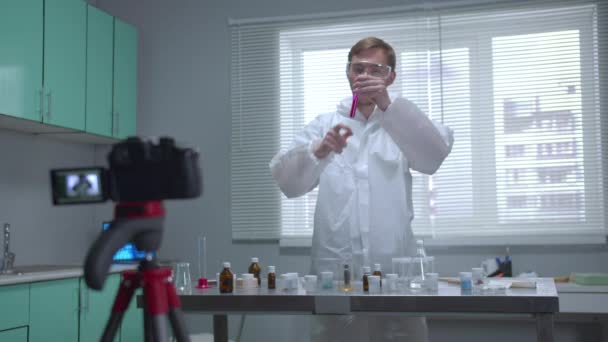 Man in protective workwear shake tube with chemical on camera in the laboratory — 비디오