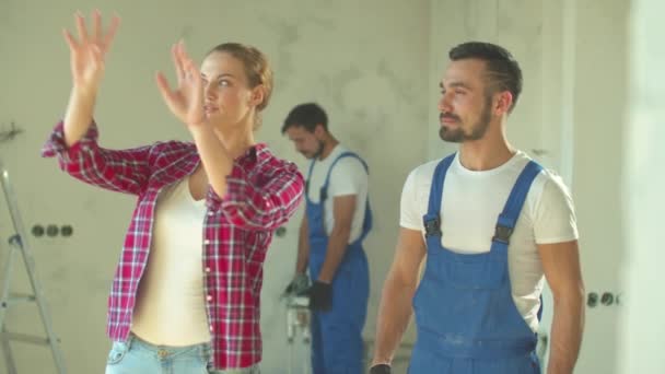 Vrouw praat over reparatie in de flat aan bouwer, slow motion — Stockvideo