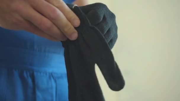 Close up, man puts on protective gloves — Stock Video