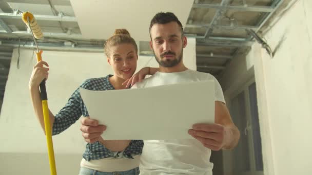 Man en vrouw kijken naar tekenen en bespreken het — Stockvideo