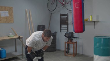Man professionally hits boxing punching bag, slow motion